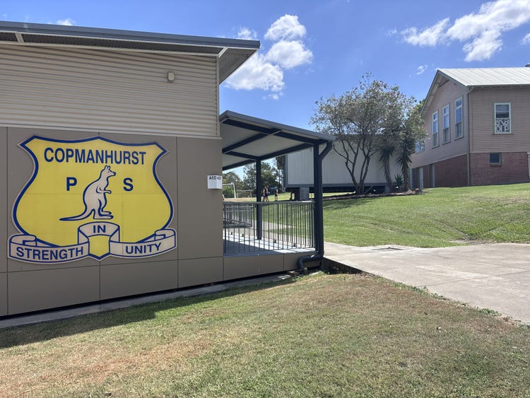 photo of the side of the office building with our school logo.