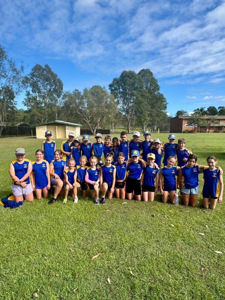 students kneeling and standing together after representing our school at our small schools cross country